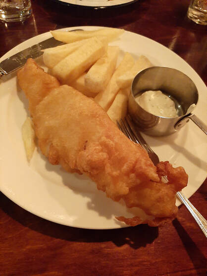 Fish and chips dinner with tartar sauce on the side