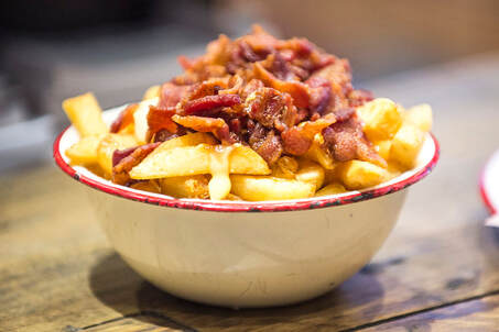 Canadian style poutine topped with bacon from bread meats bread