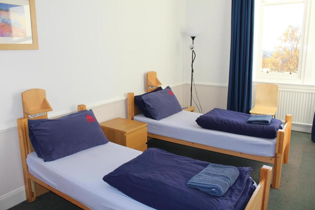 Two twin beds inside of Glasgow youth hostel
